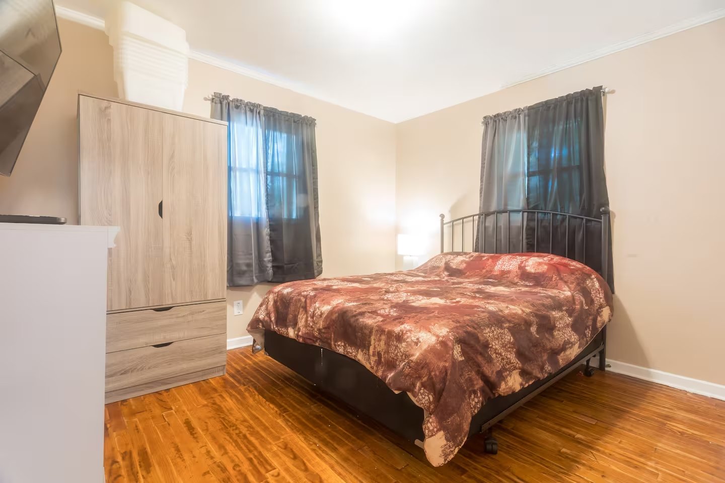 Queen bedroom with hardwood floors